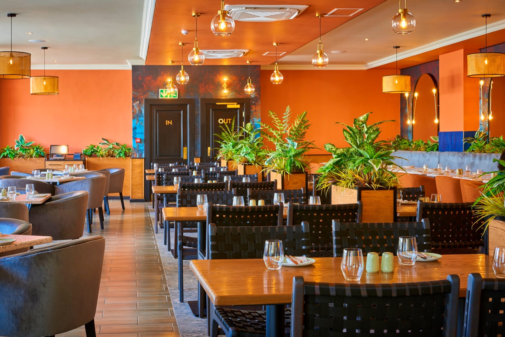 Warm restaurant with orange walls and wooden tables at Mmabatho Palms, Mahikeng