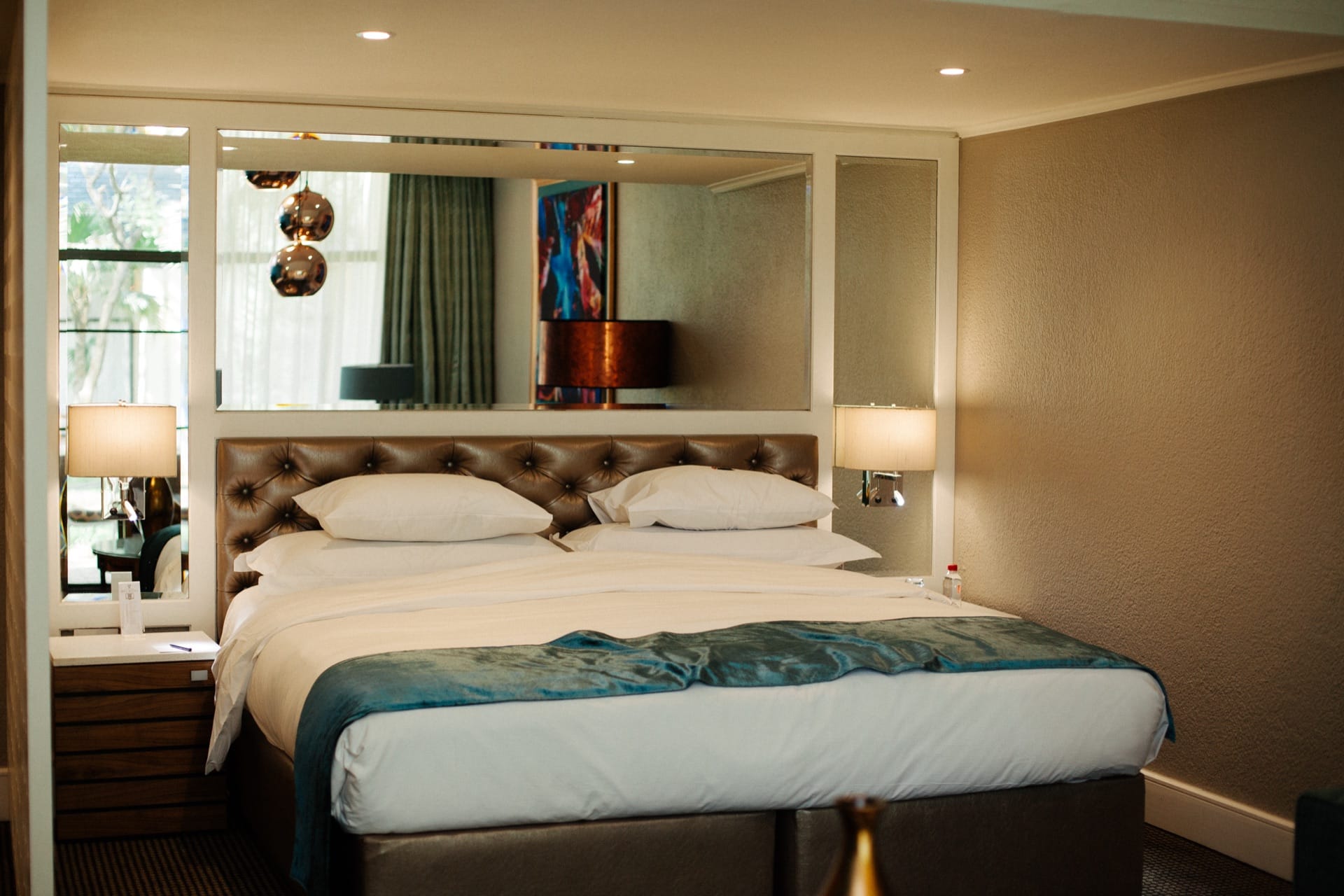 Executive Villa king bed with tufted leather headboard at Walmont at Mmabatho Palms, Mahikeng